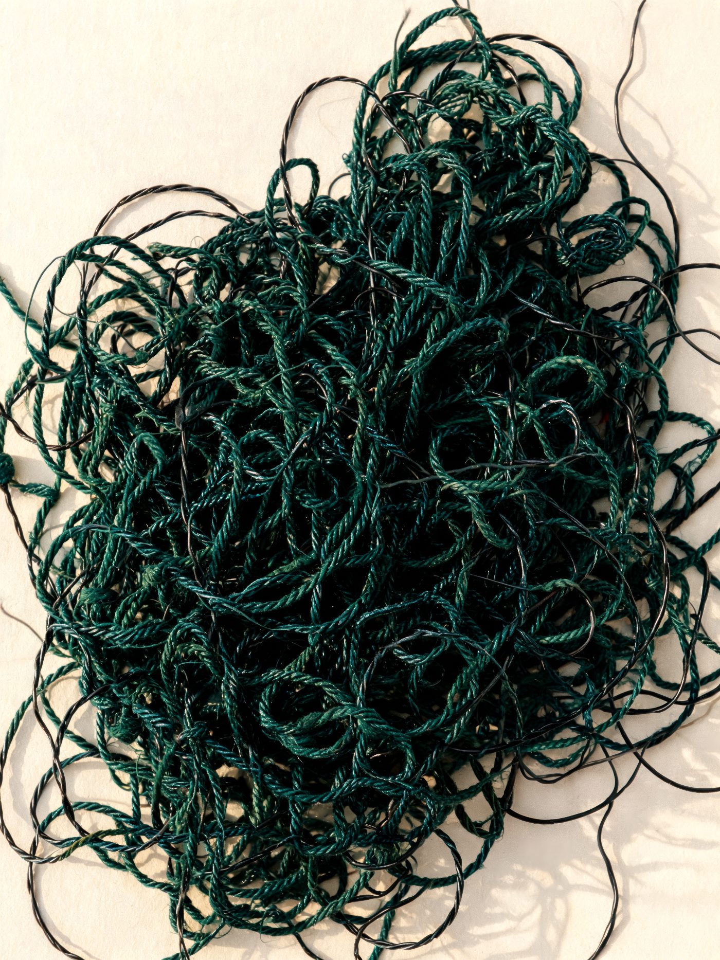 A tangle of petrol-green thread